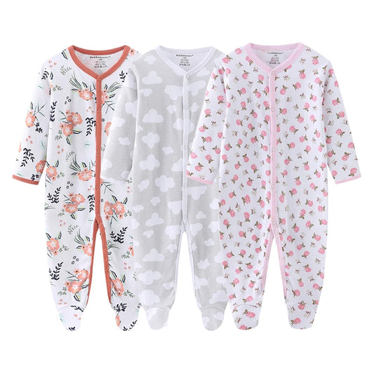Three baby onesies with floral, polka dot, and animal prints on a white background