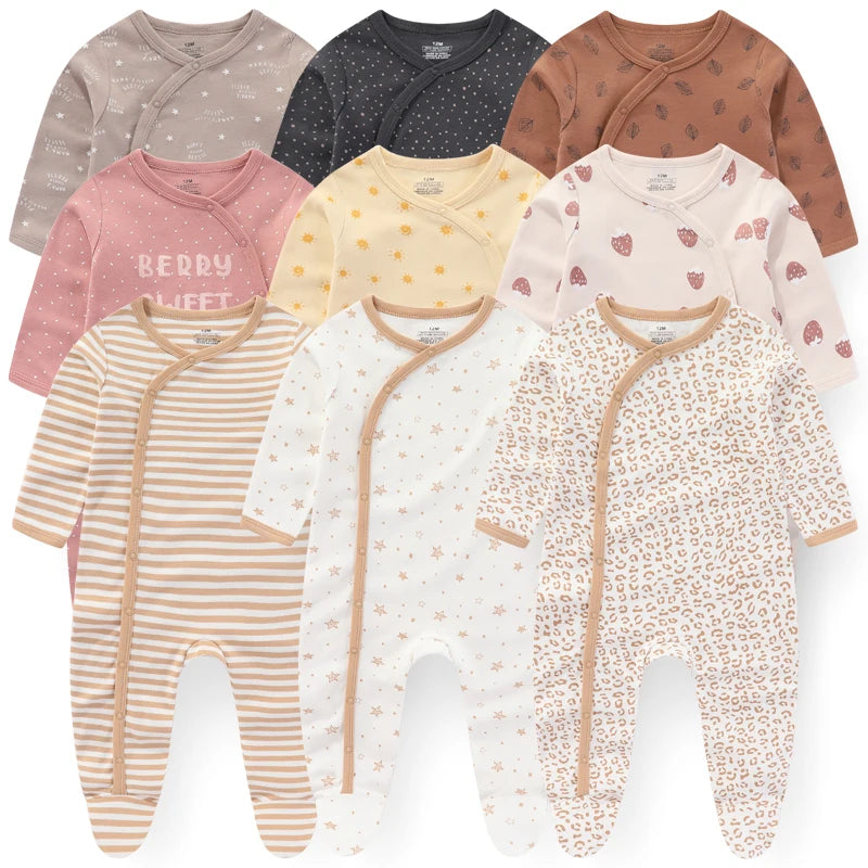 Collection of baby onesies with various patterns on a white background