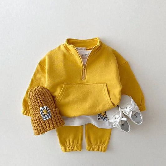 Yellow children's outfit with matching hat, pants, and shoes on a white background