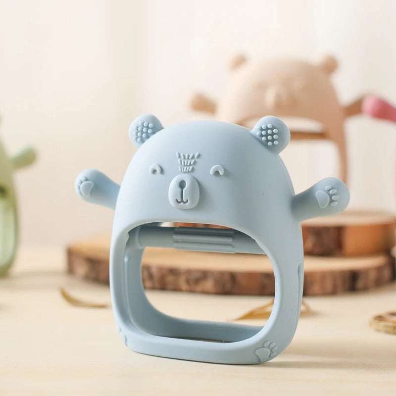 Blue bear-shaped teething ring on a neutral background