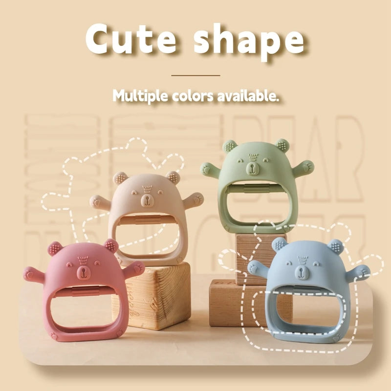 Four cute animal-shaped baby teething rings in pink, green, and blue on a wooden surface with 'Cute shape' text above.
