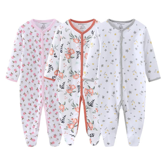 Three baby onesies with different patterns on a white background