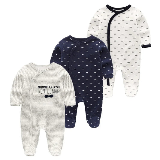 Three baby onesies in different patterns on a white background