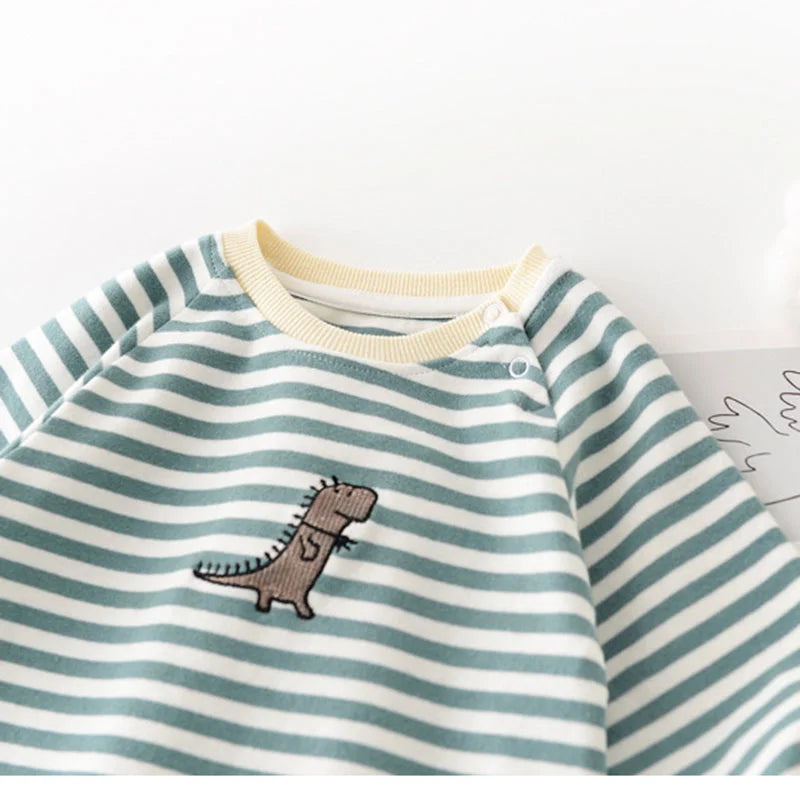 Striped shirt with a dinosaur embroidery on a white background