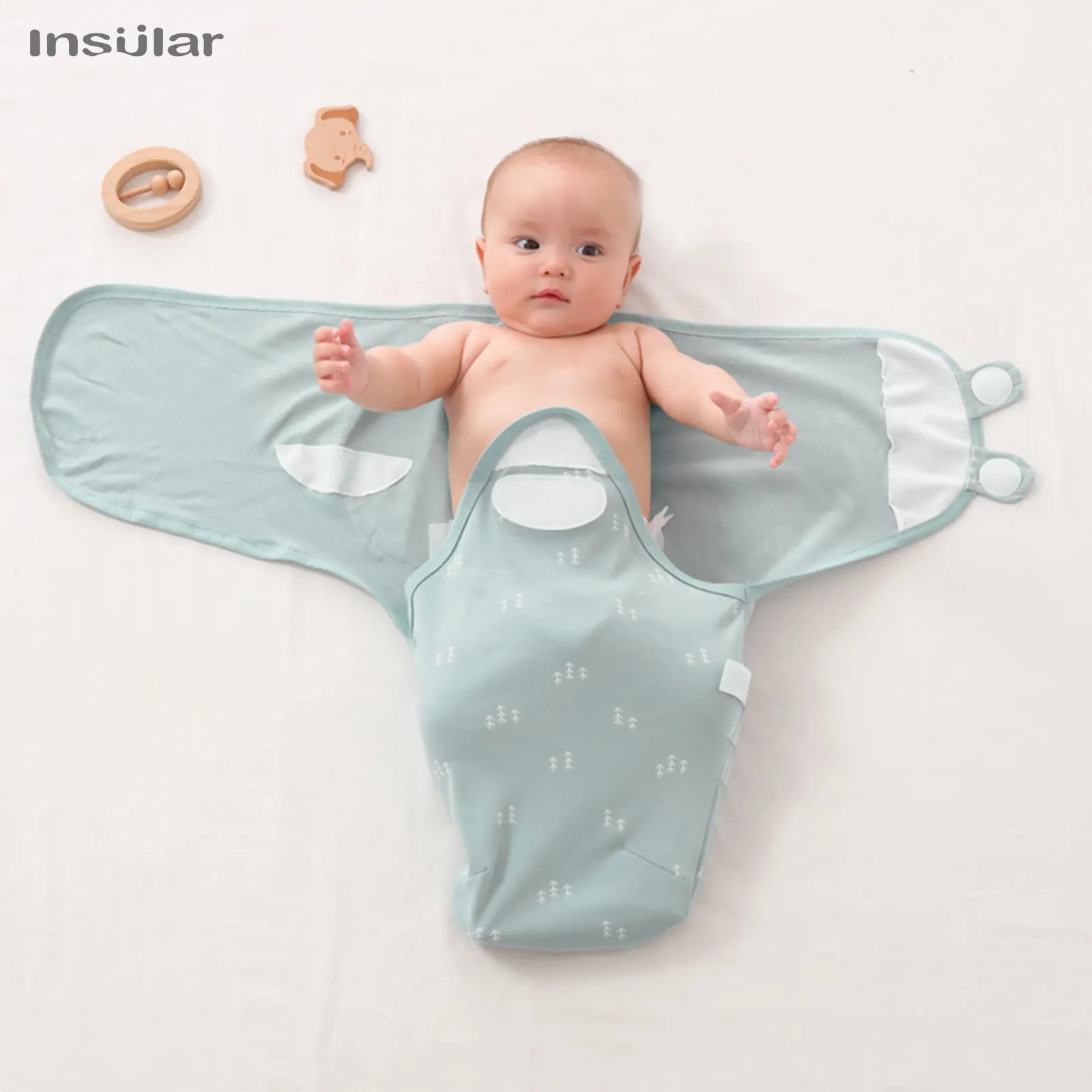 Baby lying on a light blue wrap with 'Insular' branding on a white background