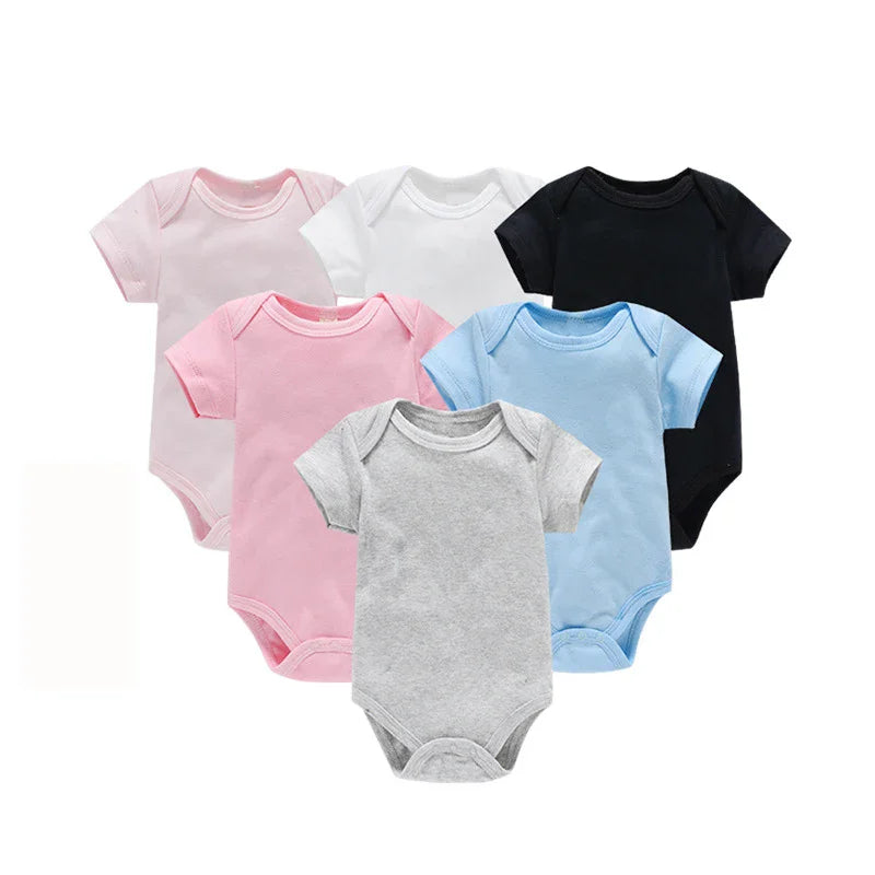 Set of five baby bodysuits in pink, white, black, blue, and gray on a white background.