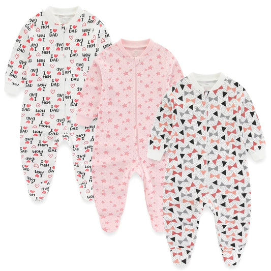 Three baby onesies with different patterns on a white background