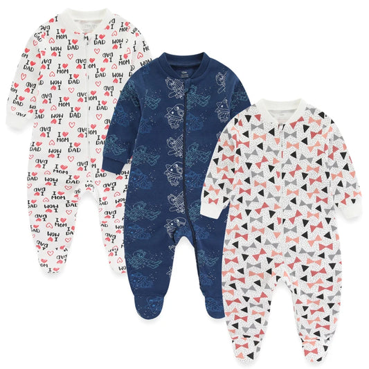 Three baby onesies with different patterns on a white background
