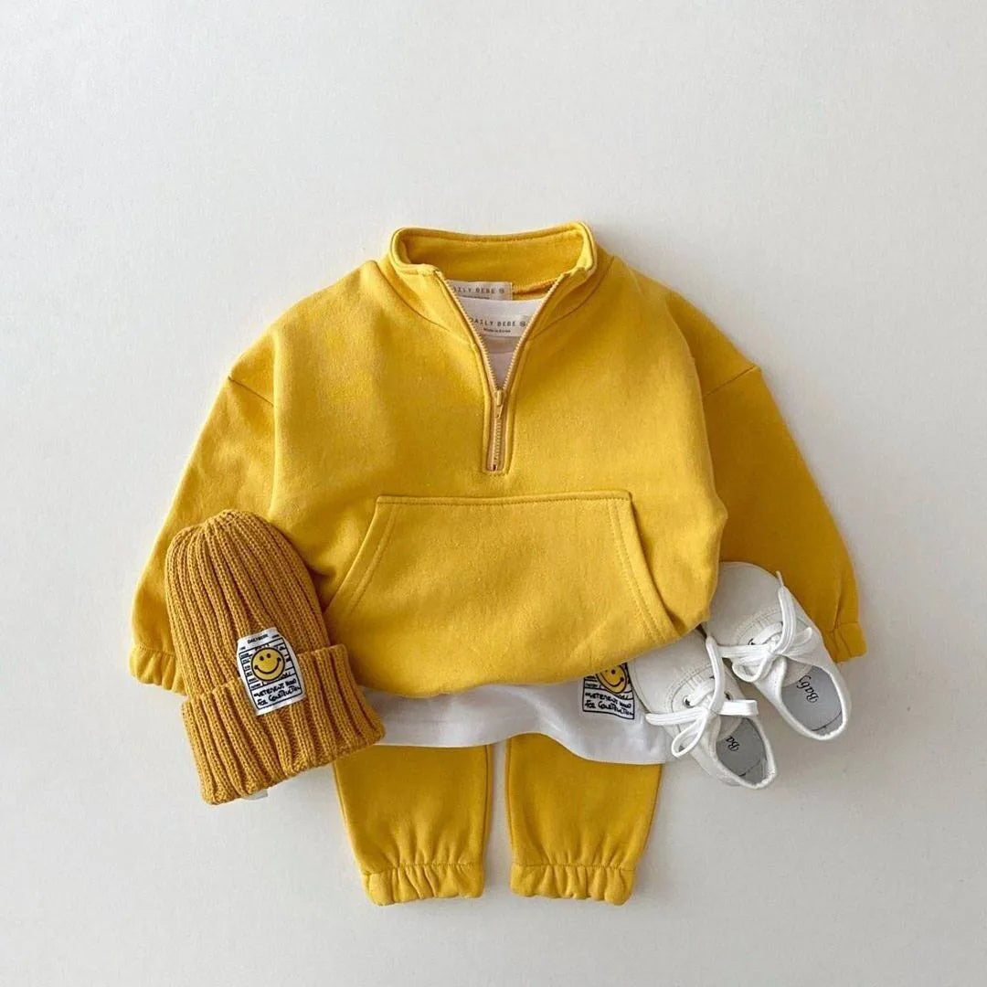 Yellow children's outfit with matching hat, pants, and shoes on a white background